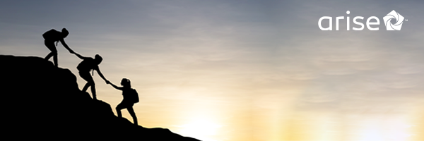 Women climbing up a mountain during sunrise.